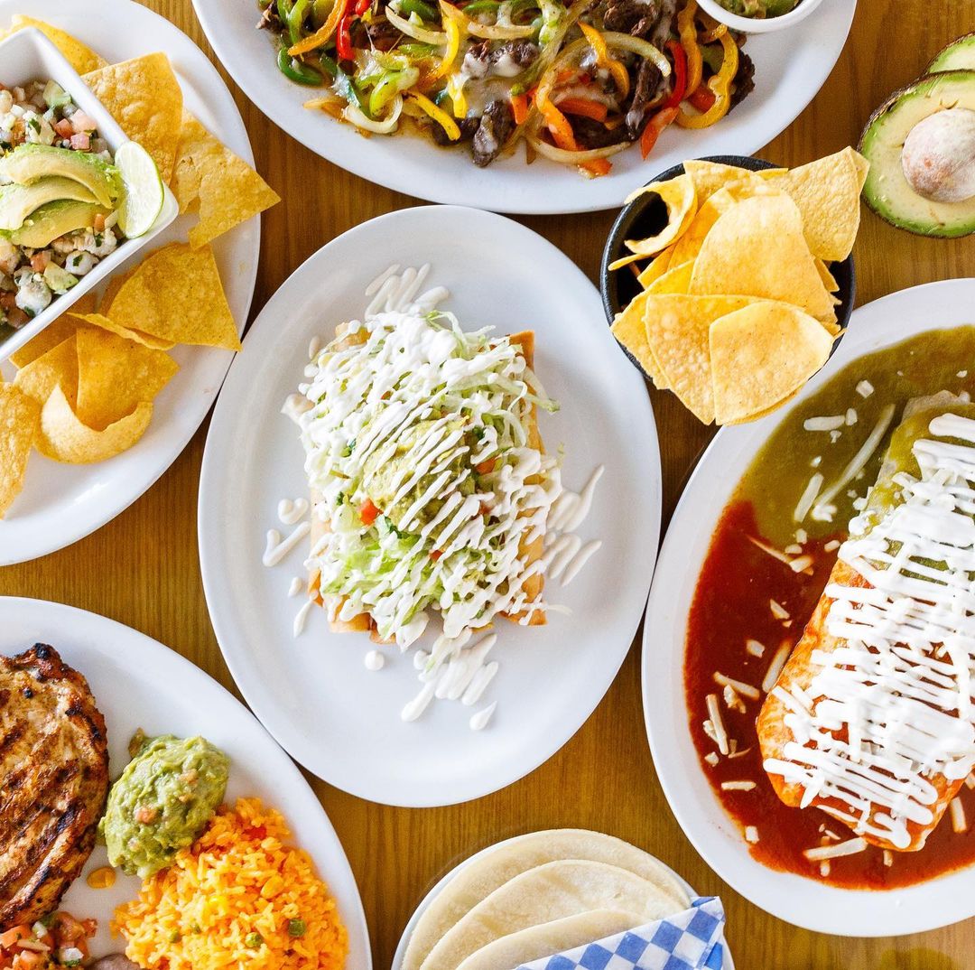 An assortment of Mexican dishes including burritos, tacos, and nachos.