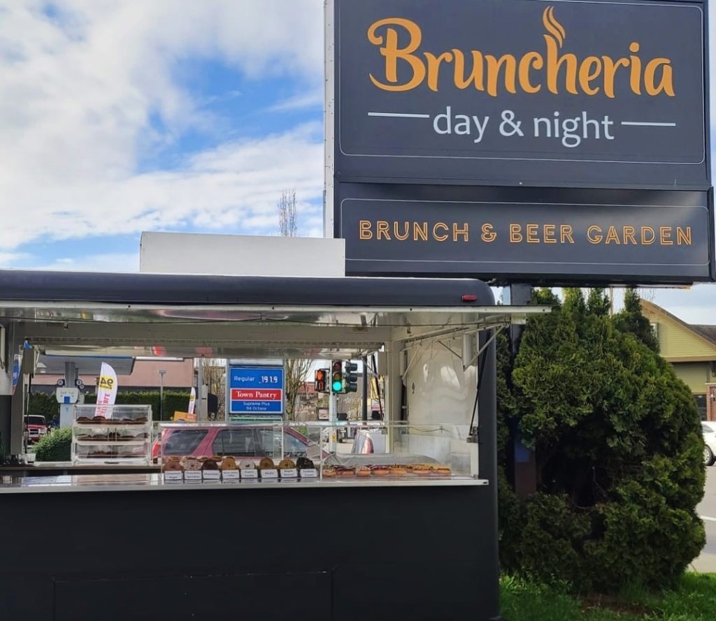 Bruncheria's dark navy blue food truck selling donuts
